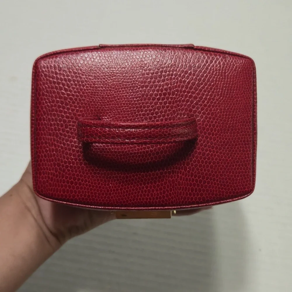 Wolf Designs red pebbled leather jewelry box with gold hardware and key